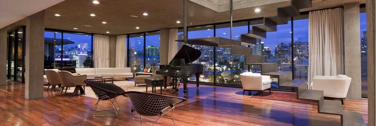 Sala de apartamento com janelas de vidro do piso ao teto e vista para a cidade